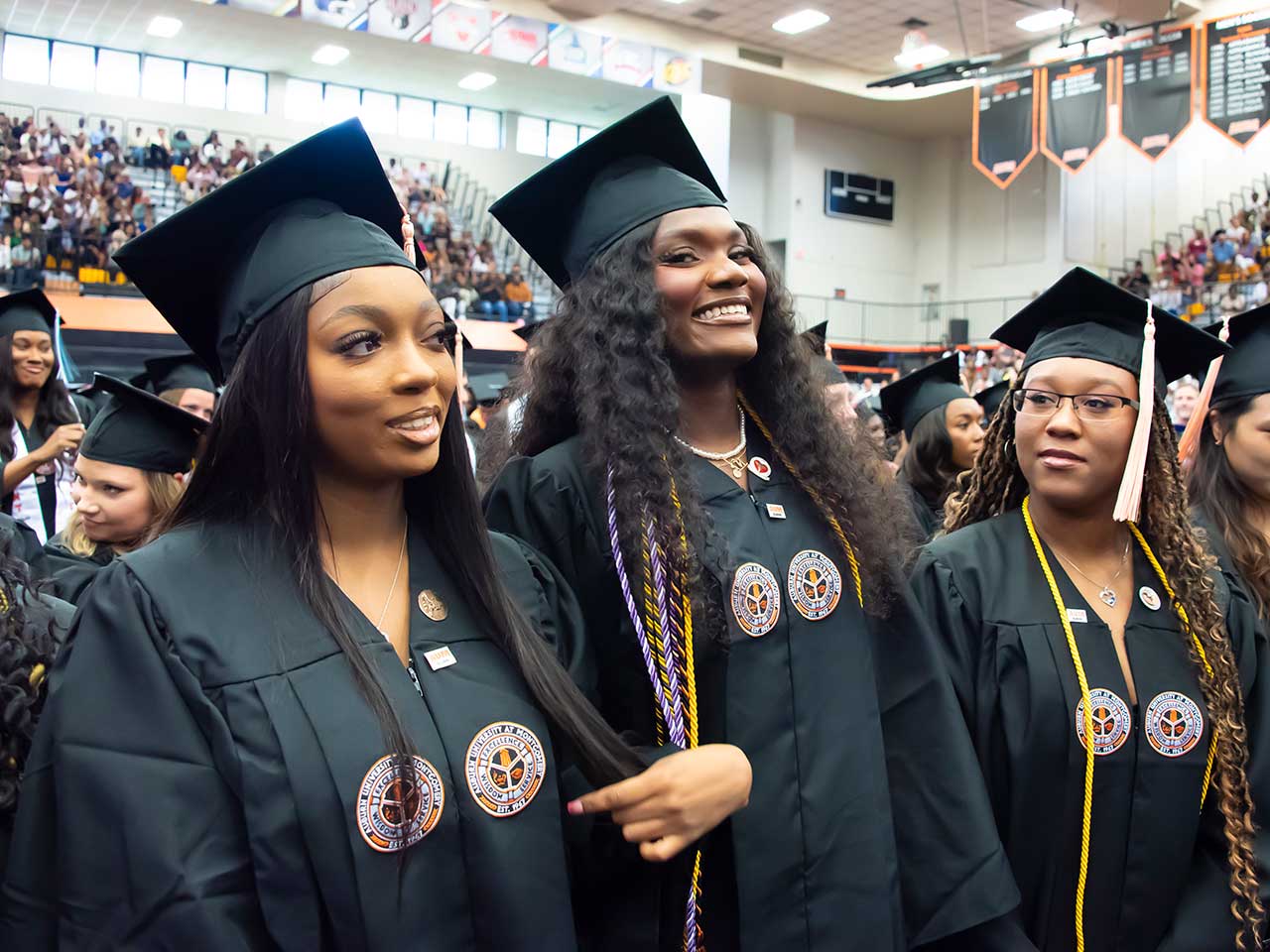 a group of people standing in front of a crowd posing for the camera